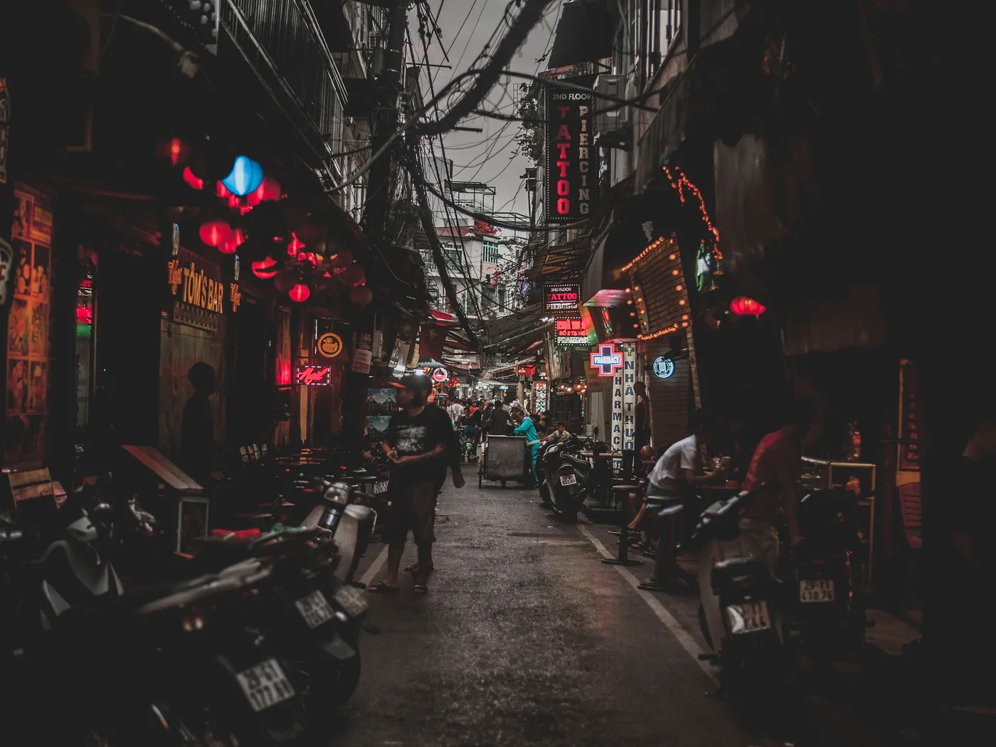 A crowded Hanoi Old Quarter street at night with food stalls